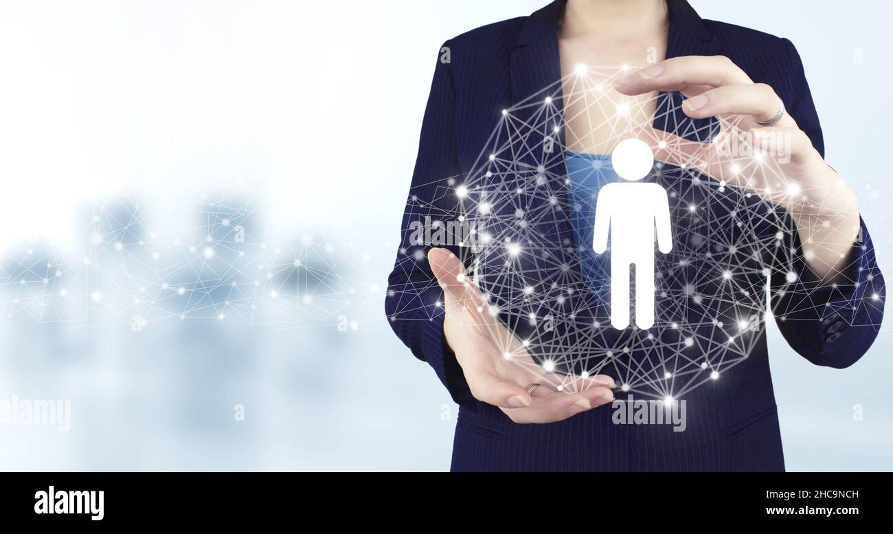 HR Human Resources Recruitment Employment. Two hand holding virtual holographic Human, Leader icon with light blurred background. Social media concept Stock Photo