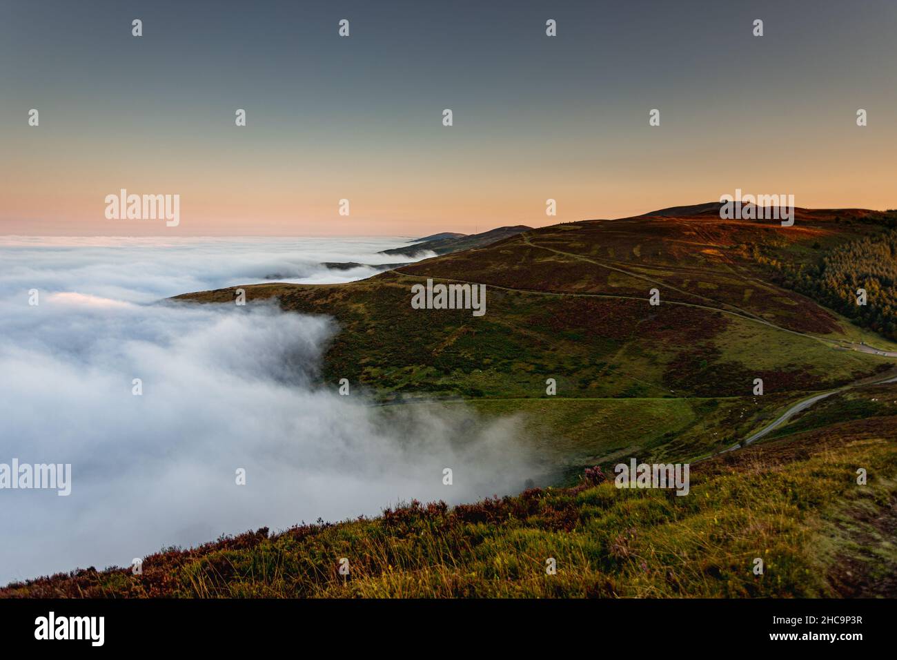 Clwydian Range in fog at sunrise, North Wales Stock Photo