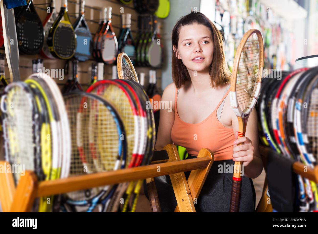 Female teen choosing wood racket for squash Stock Photo Alamy