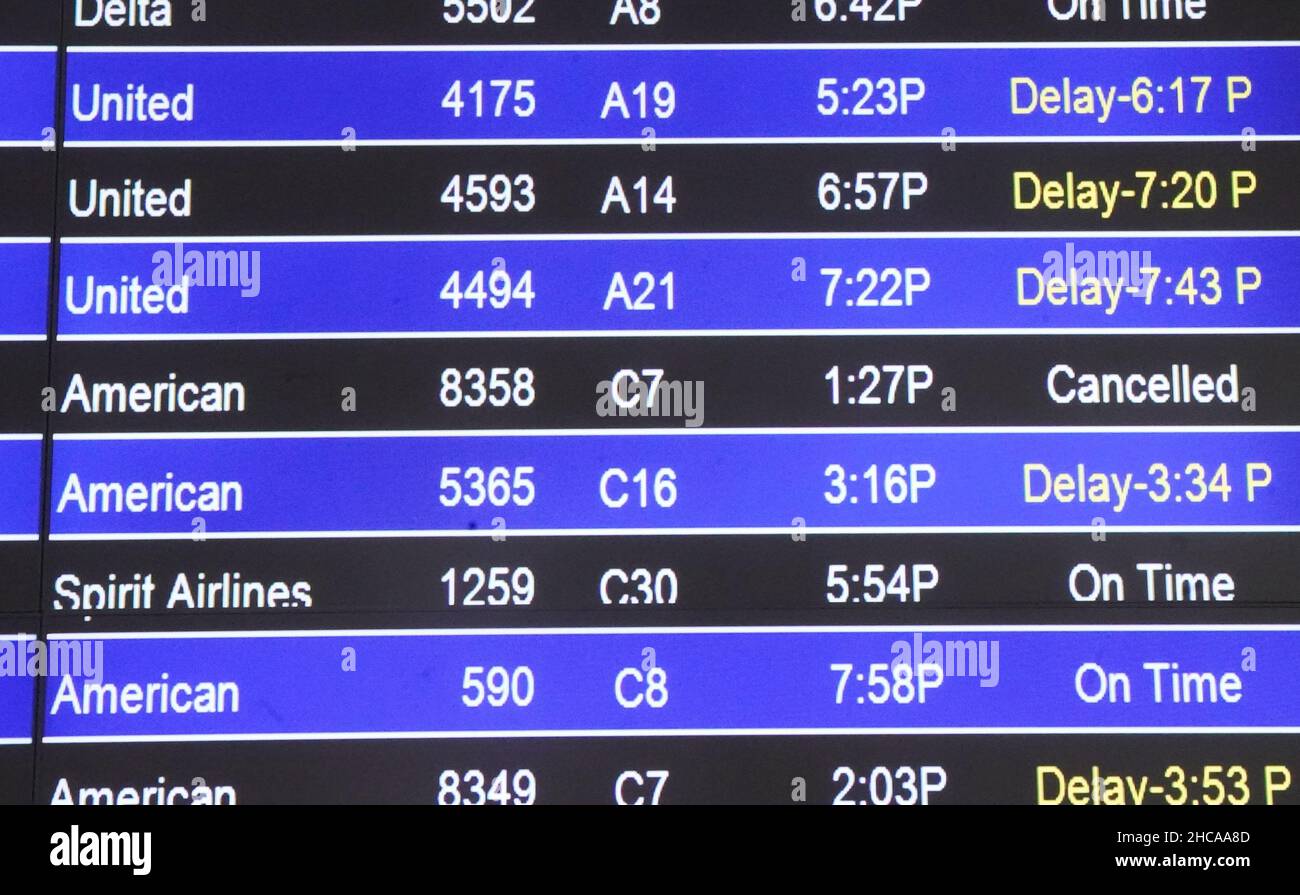St. Louis, United States. 26th Dec, 2021. Travelers are greeted by delayed or cancelled flights on the status board at St. Louis-Lambert International Airport in St. Louis on Sunday, December 26, 2021. Over 4,000 flights have been delayed or canceled across the country because of the latest omicron coronavirus surge. United and Delta have blamed coronavirus for staffing problems that led to cancellations. Photo by Bill Greenblatt/UPI Credit: UPI/Alamy Live News Stock Photo