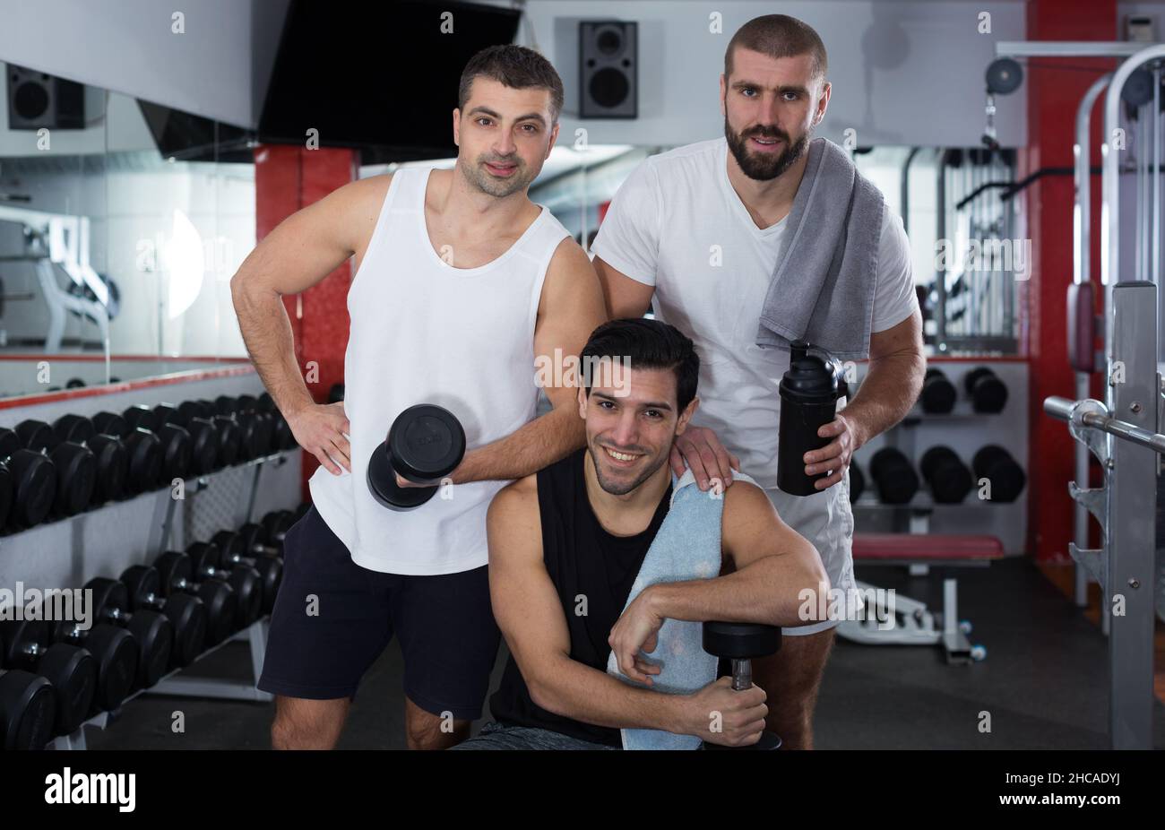 Three male friends in gym Stock Photo