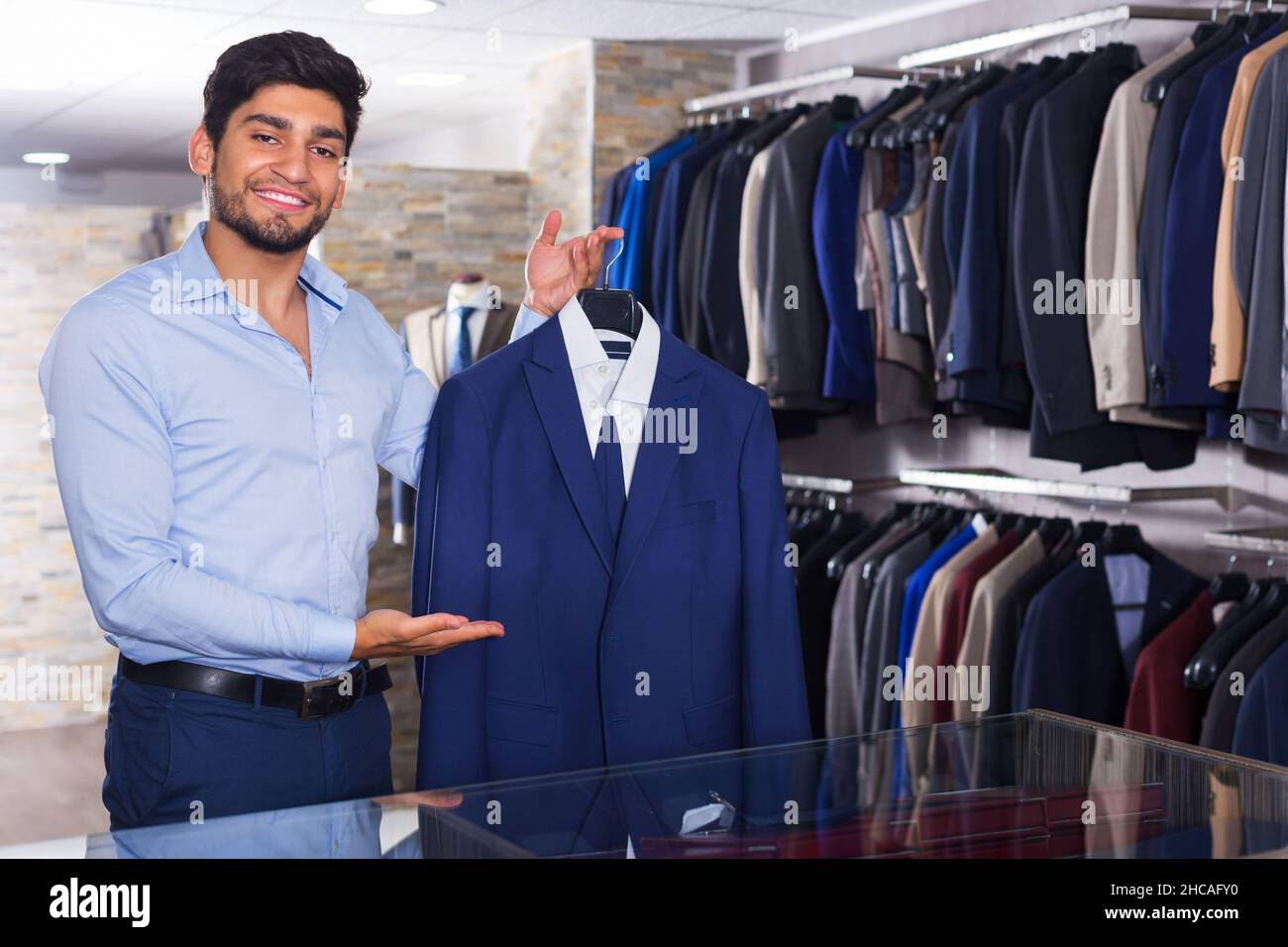 Man demonstrating suit in shop Stock Photo - Alamy