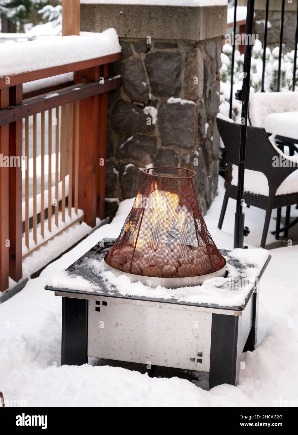 Outdoor gas fireplace on a snowy patio in winter Stock Photo Alamy
