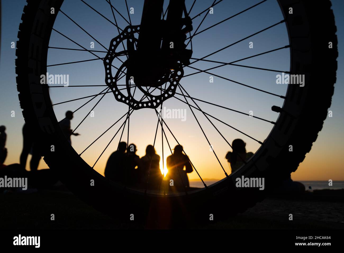 Silhouette of group of people against the sunset. Salvador, Bahia, Brazil. Stock Photo