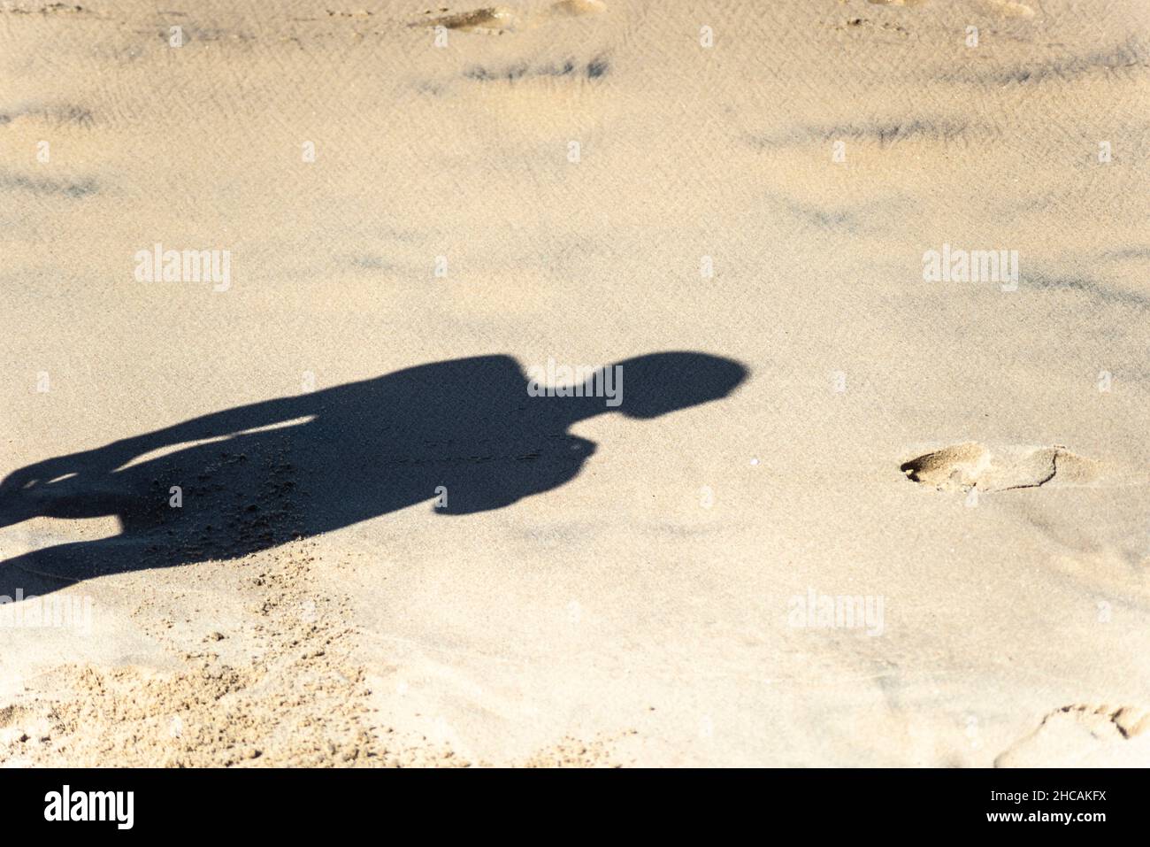 Shadow of a person on the sand of the beach on a strong sunny day. Salvador Bahia Brazil Stock Photo