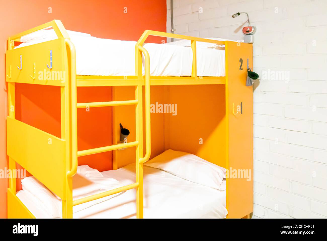 Yellow Lockers and Bunk beds with freshly made beds in a modern hostel room Stock Photo Alamy