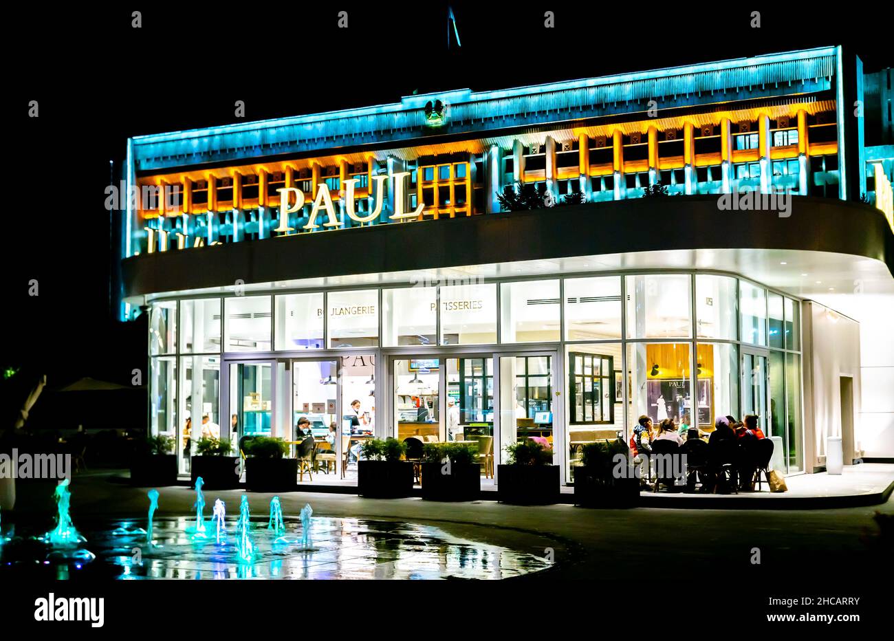 PAUL bakery, cafe, and restaurant building exterior. Paul cafe lit up