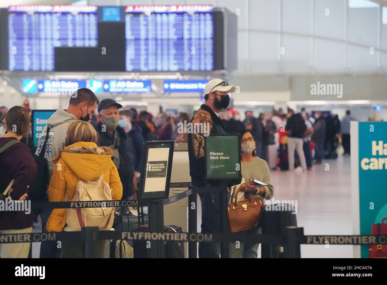 St. Louis, United States. 26th Dec, 2021. Travelers stand in line for ticketing at St. Louis-Lambert International Airport in St. Louis on Sunday, December 26, 2021. Over 4,000 flights have been delayed or canceled across the country because of the latest omicron coronavirus surge. United and Delta have blamed coronavirus for staffing problems that led to cancellations. Photo by Bill Greenblatt/UPI Credit: UPI/Alamy Live News Stock Photo
