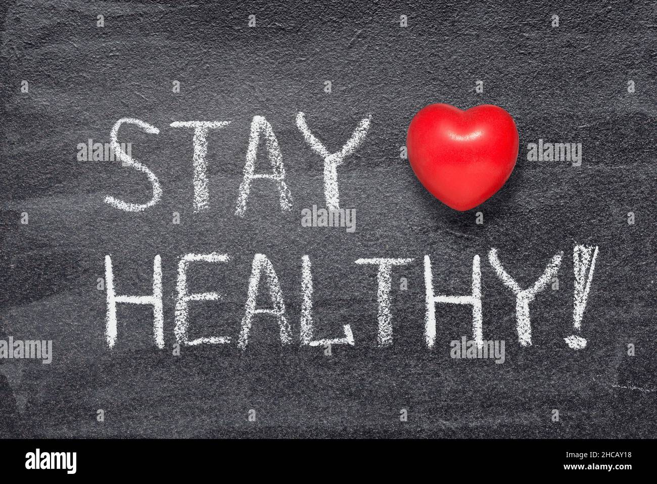 stay healthy phrase written on chalkboard with red heart symbol Stock Photo
