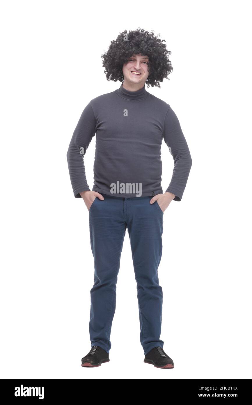 in full growth. Jolly young man in a curly wig. Stock Photo
