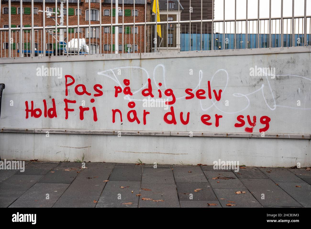 Pas på dig selv. Hold fri når du er syg. Graffiti in Gammelholm district of Copenhagen, Denmark. Stock Photo