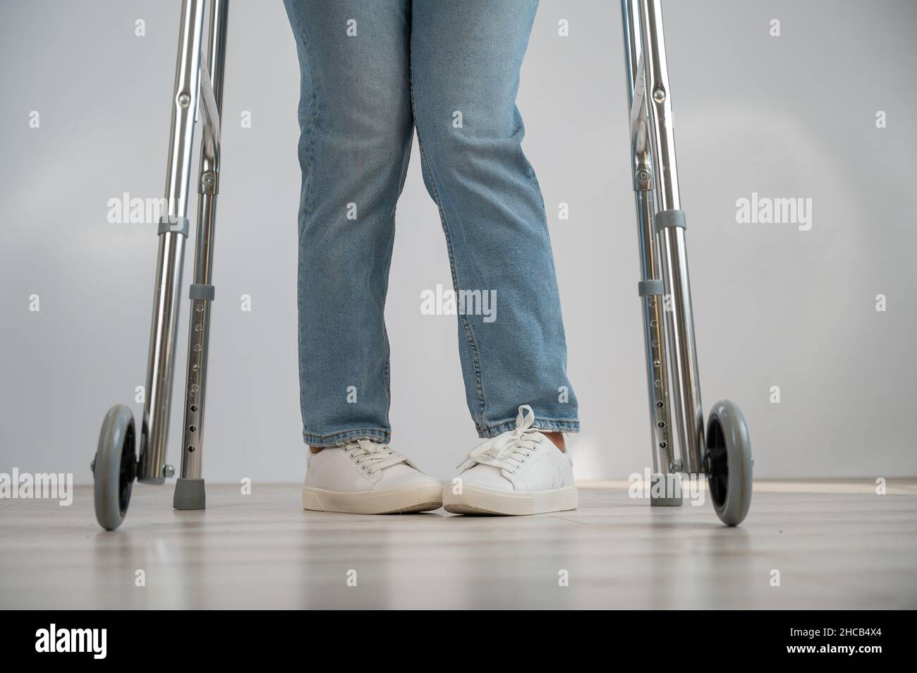 Closeup of female legs with walkers. The girl walks with the help of