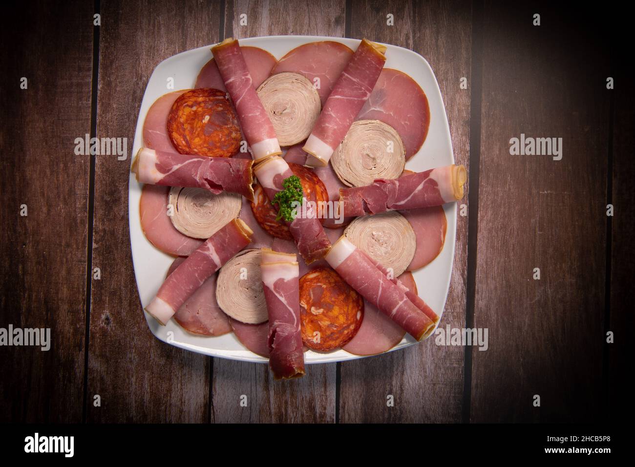 Food tray with delicious salami, pieces of sliced ham, sausage, Deli