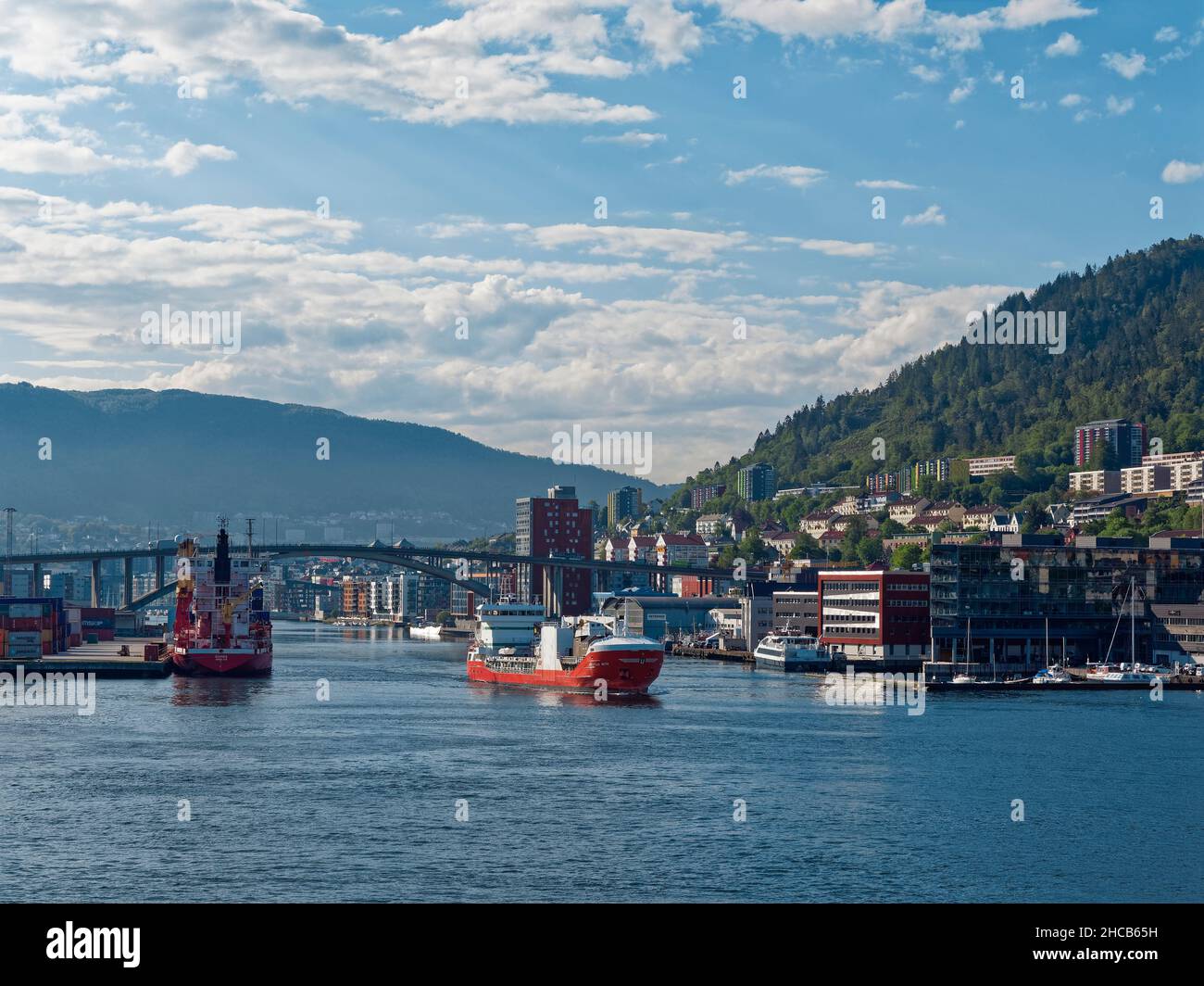 The Kristian With, a General Cargo Vessel departing Bergen Port in the early morning of a bright Summers day. Stock Photo