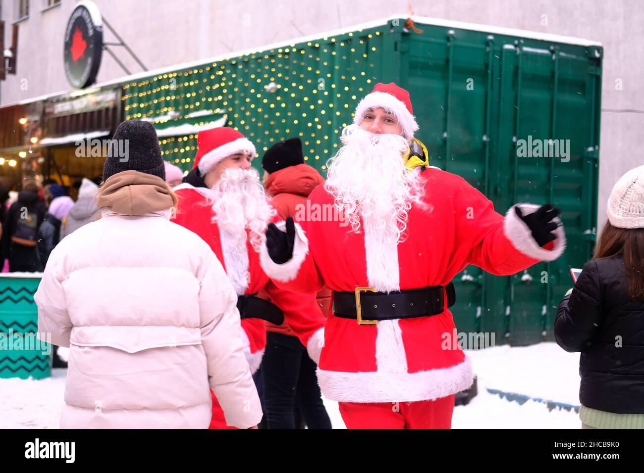 Minsk, Belarus, December 25, 2021: Two Santa Claus walk merrily among the people at the New Year's fair. Stock Photo
