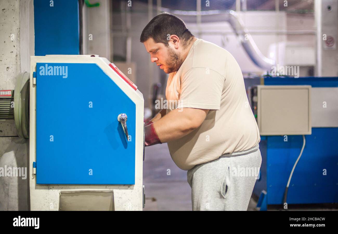 Professional worker technician machinist work on vacuum sandblasting