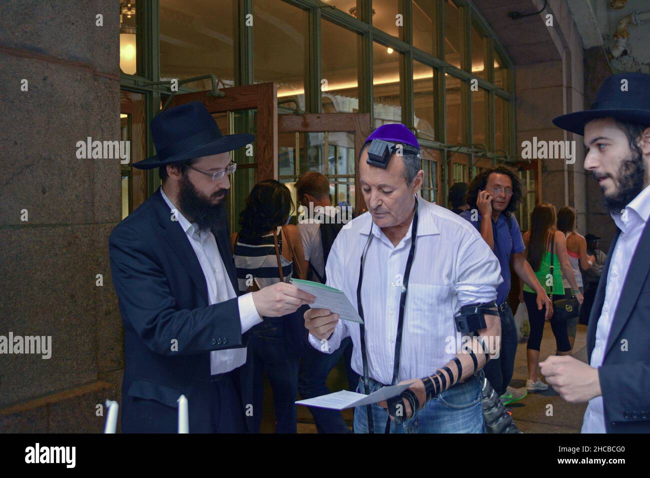 Chabad orthodox Jewish boys reaching out and urging fellow Jews to pray wearing tefillin. At Grand Central Station in Manhattan, N Stock Photo
