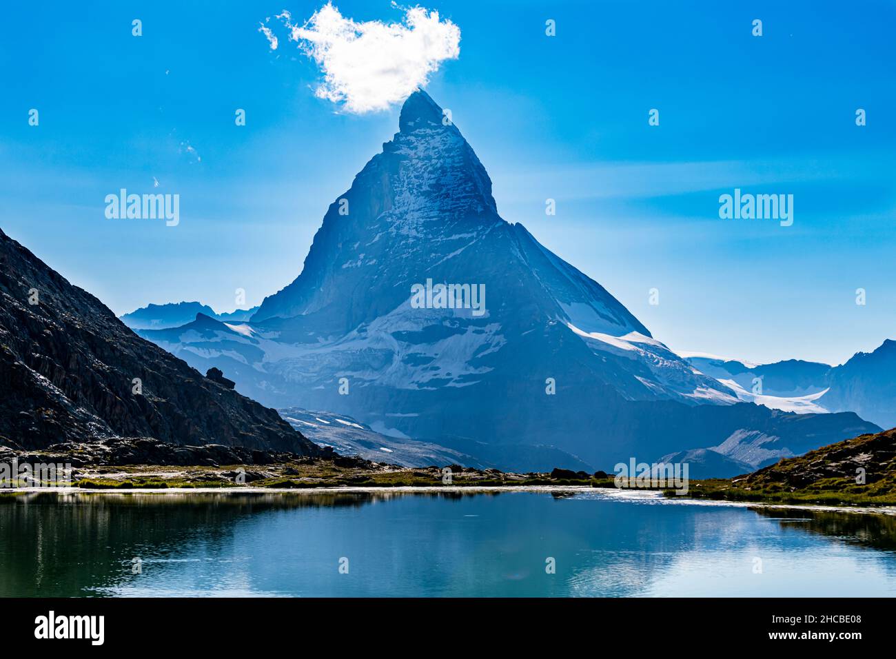Alpine lake with Matterhorn mountain looming in background Stock Photo