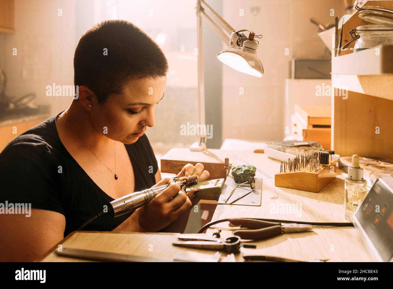Female expert checking size of silver ring in workshop Stock Photo
