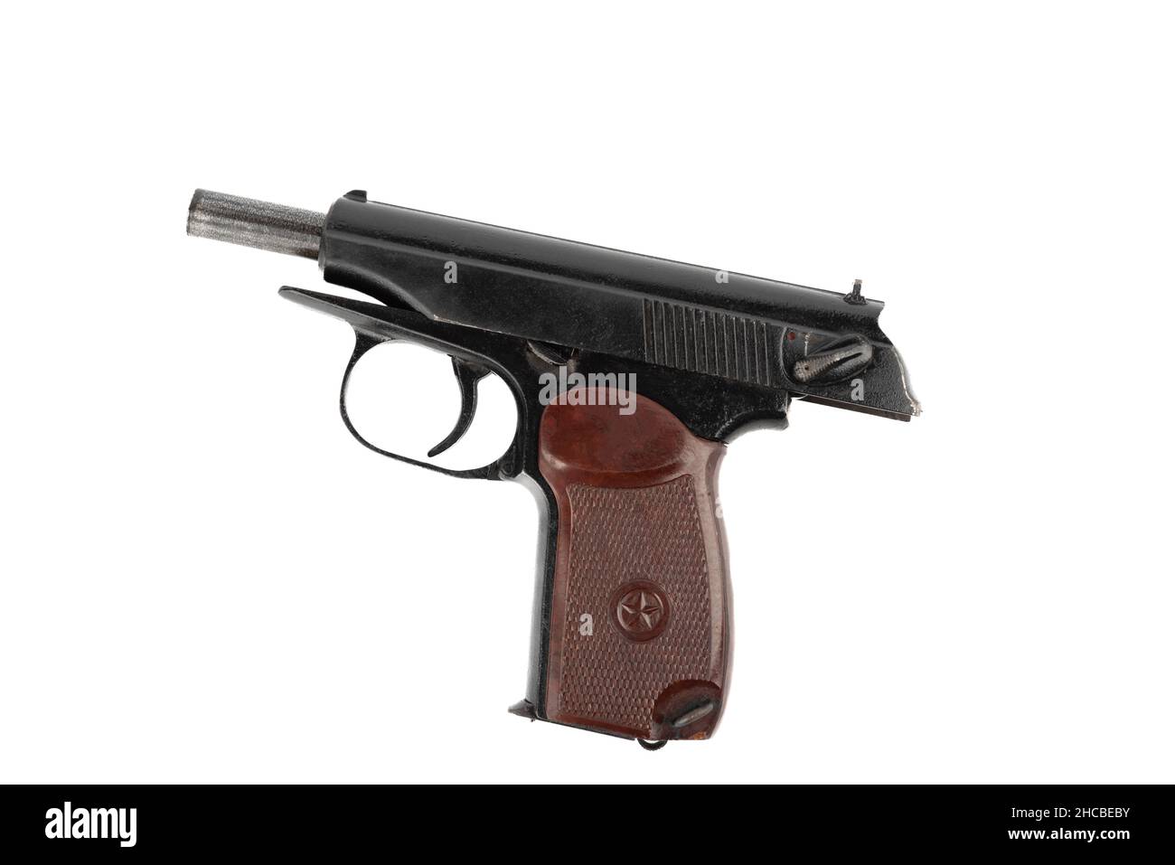Close-up on a Makarov pistol with the bolt stopped in the open position against a white background. The pistol bolt is stopped. Stock Photo