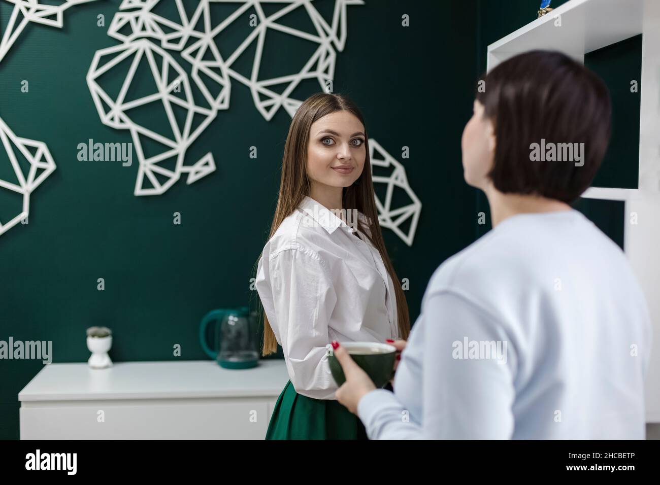 Saleswoman and colleague in travel agency Stock Photo