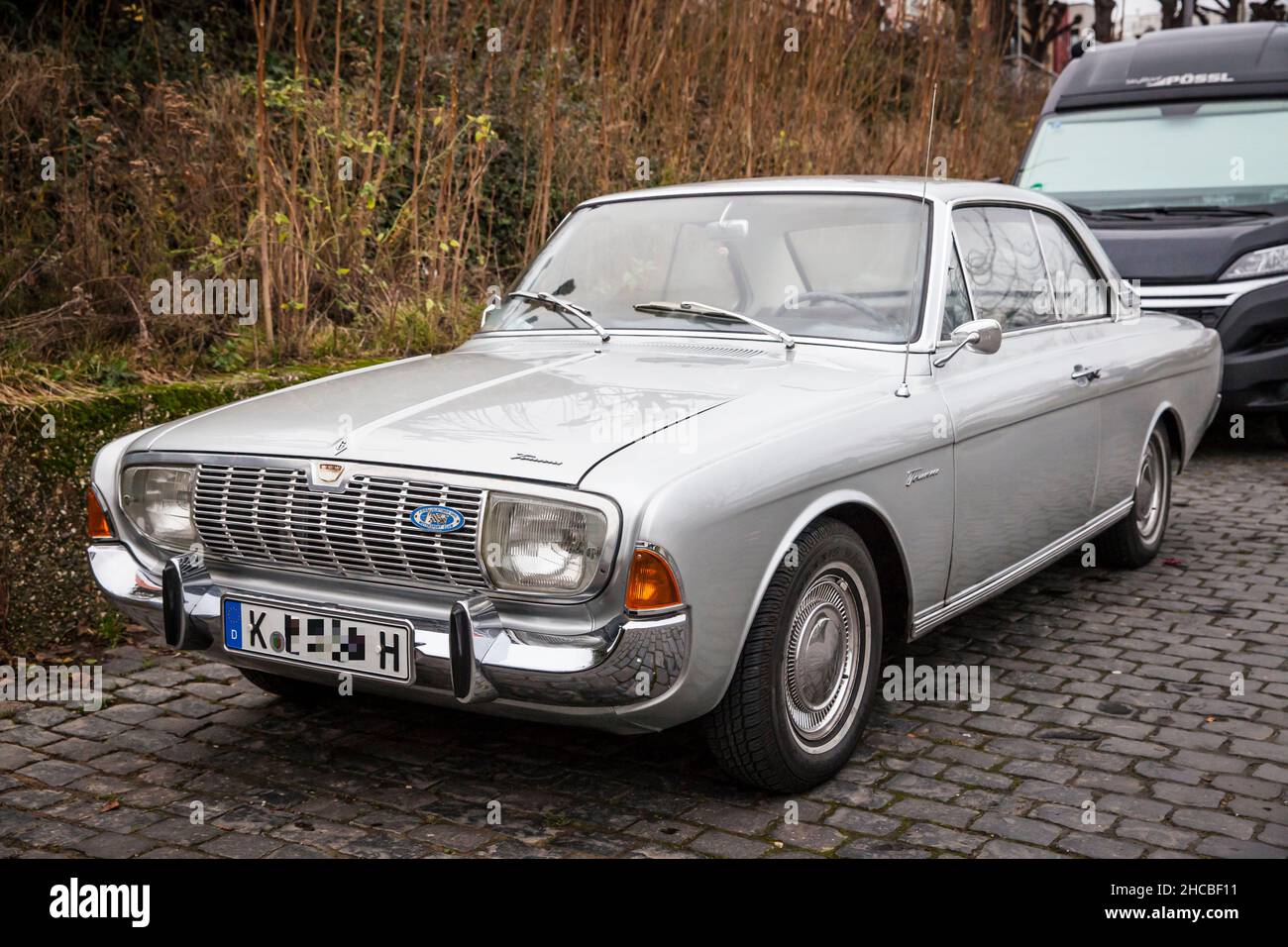 a Ford Taunus 20m TS from the 1960s is parked at the banks of the river Rhine, Cologne, Germany.  ein Ford Taunus 20m TS aus den 1960er Jahren steht a Stock Photo