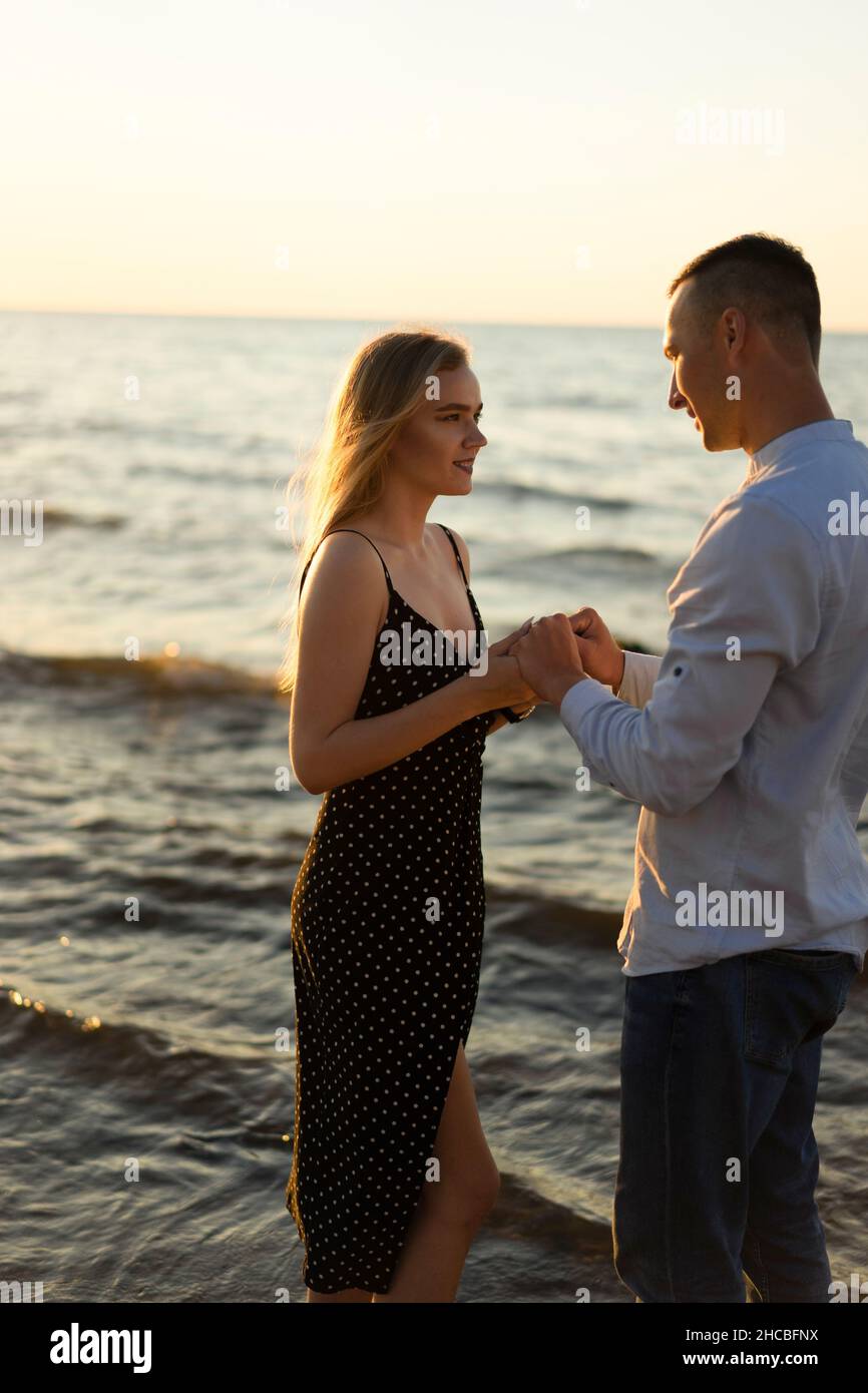 Young couple holding hands at beach Stock Photo
