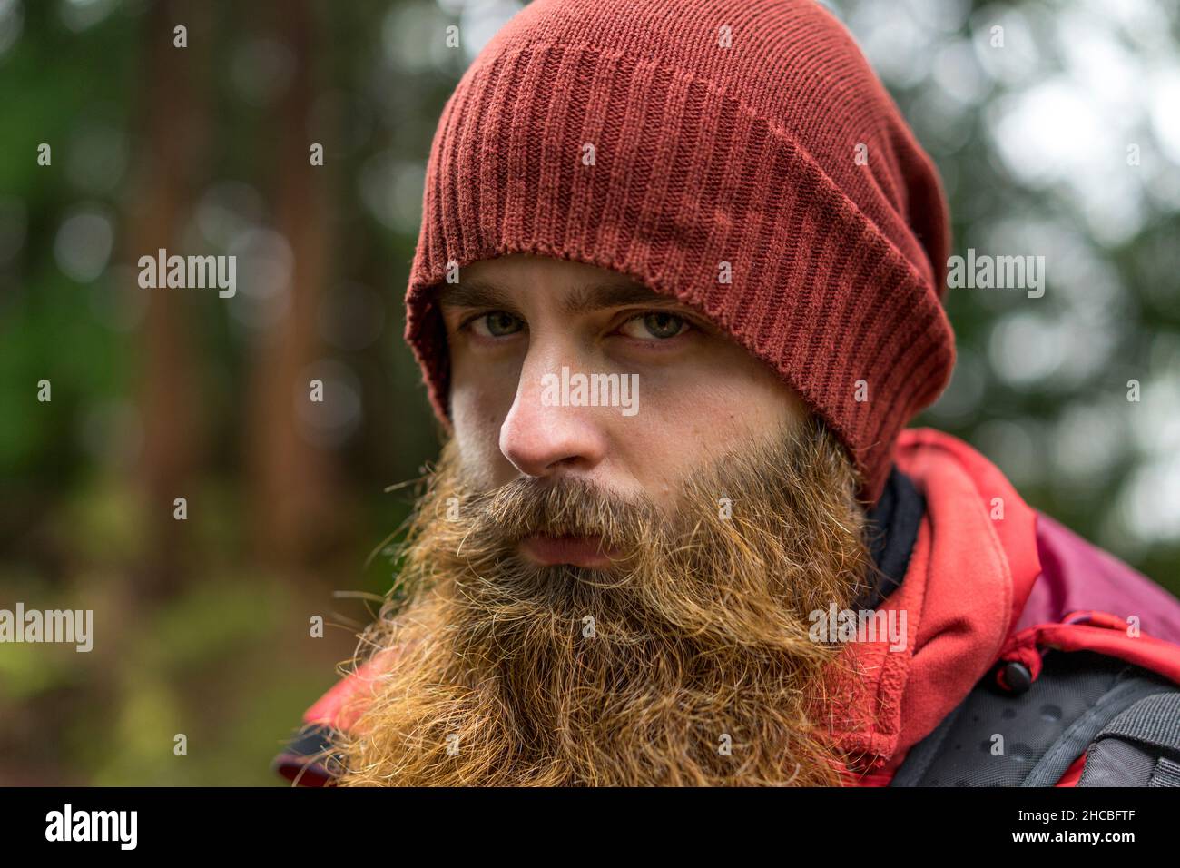 Young hipster man with brown beard wearing knit hat Stock Photo