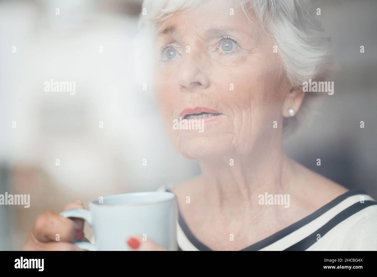 Senior woman using virtual reality simulator at home Stock Photo