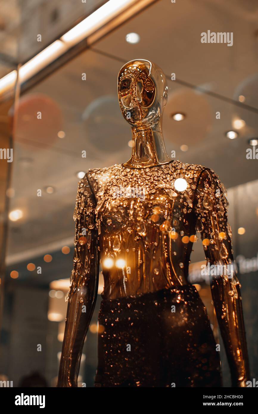 Shiny golden festive creative female mannequin with rhinestones in shop