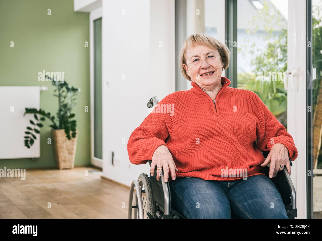 Smiling disabled woman in wheelchair at home Stock Photo - Alamy