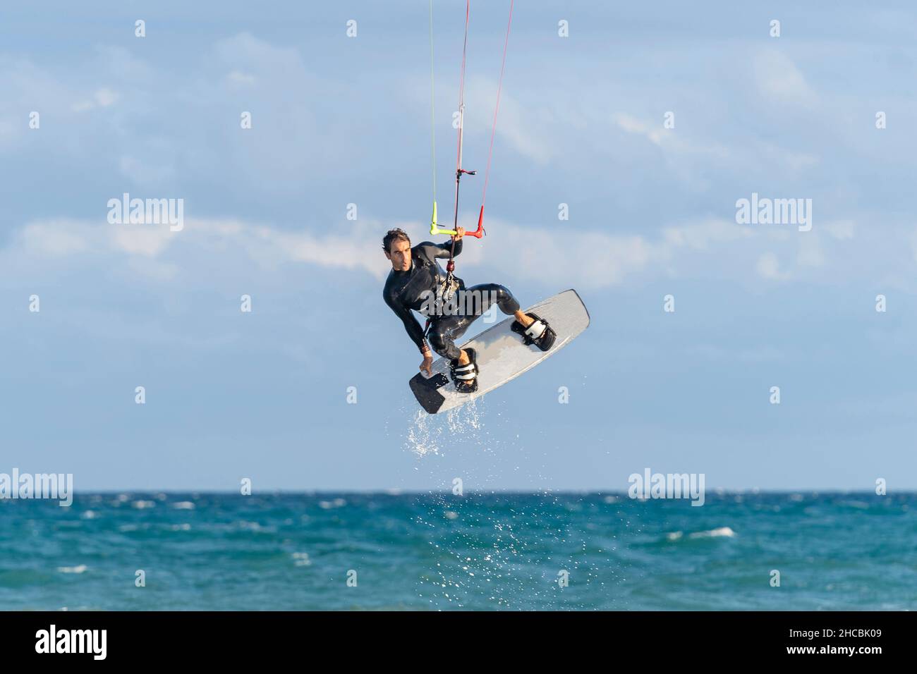 Man kiteboarding over water on vacation Stock Photo
