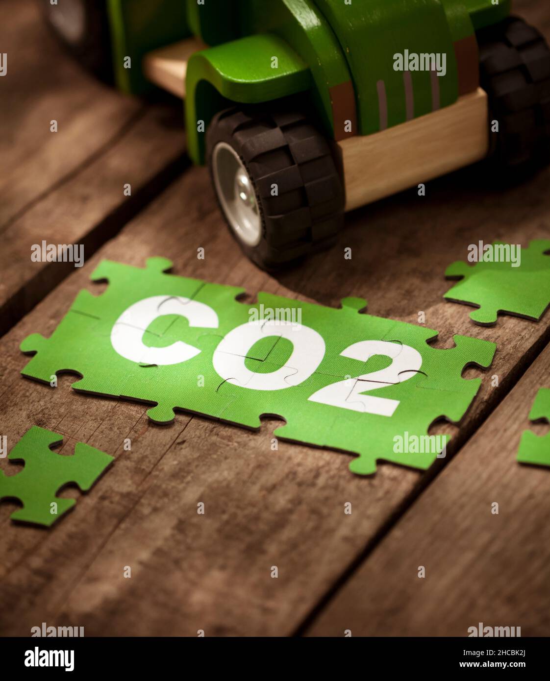CO2 jigsaw puzzle pieces by toy car on table Stock Photo