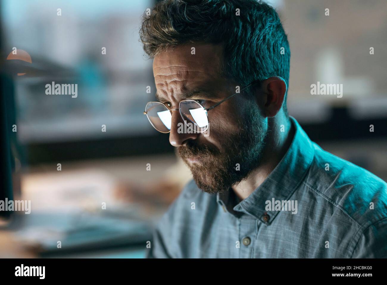 Businessman wearing eyeglasses working in office Stock Photo
