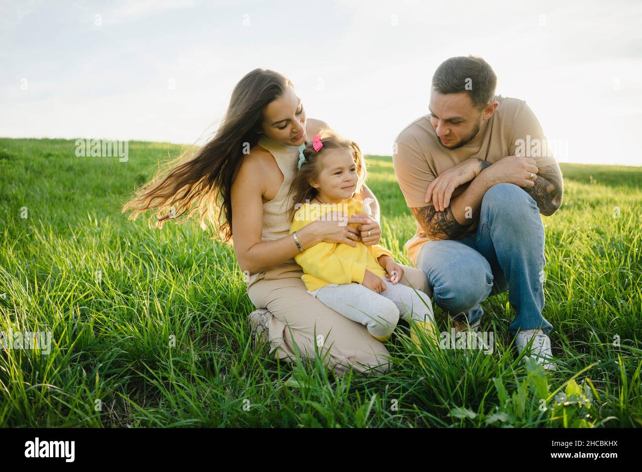 Family spending leisure time on meadow Stock Photo