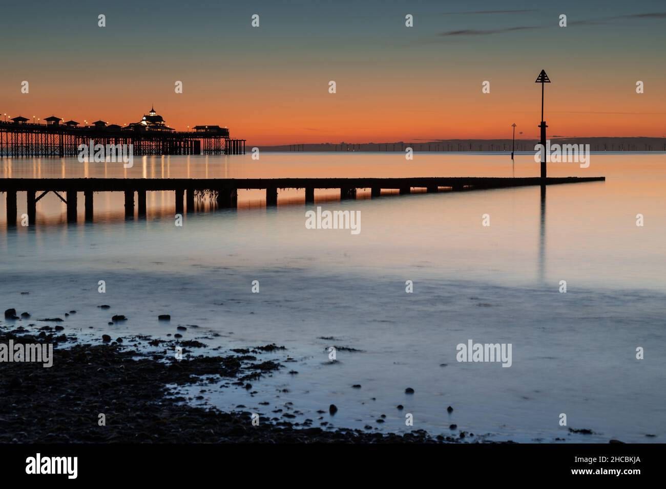 Jetty and pier at dawn on Llandudno North Shore, North Wales Stock Photo