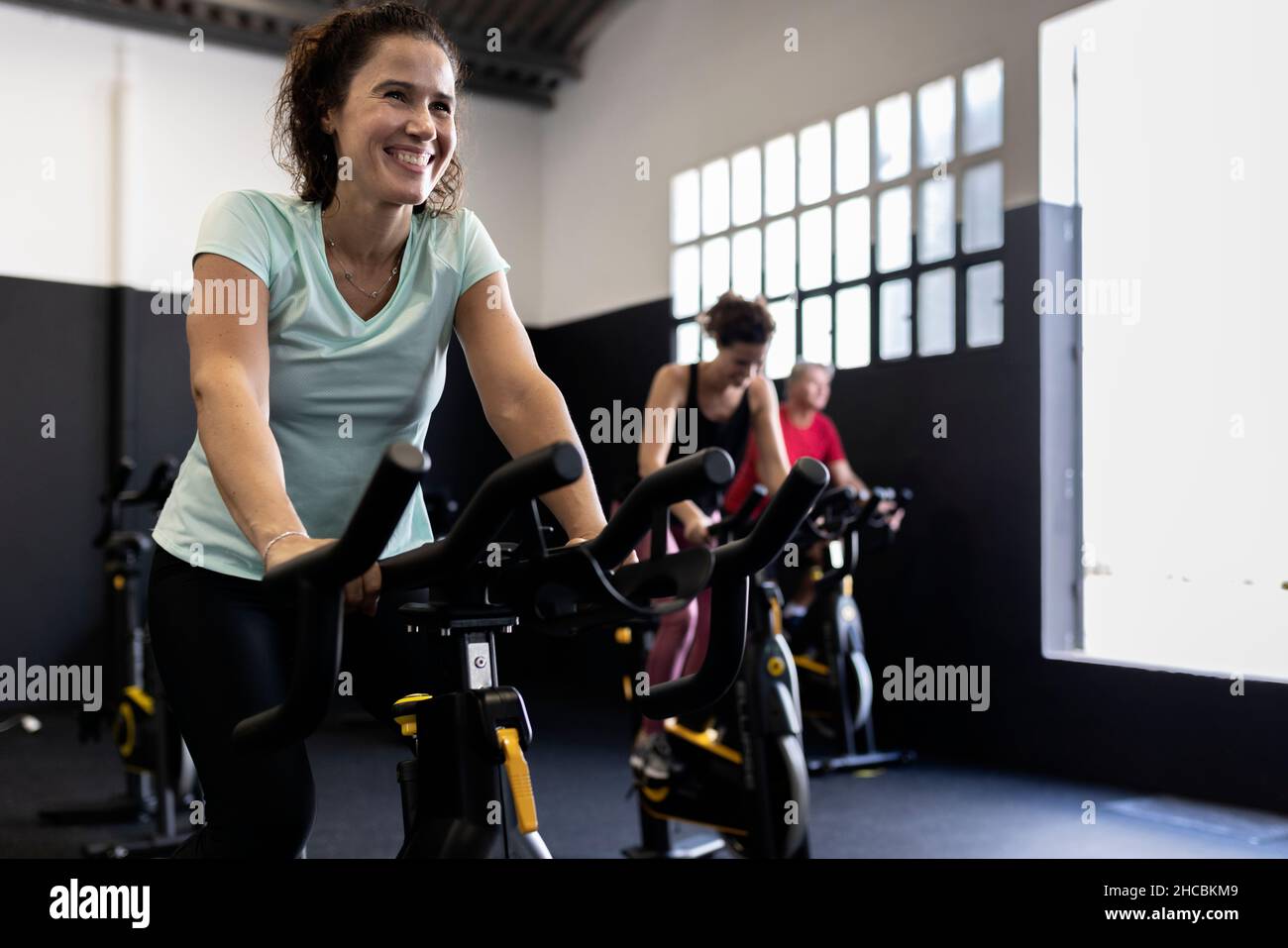 Sportsman cycling exercise bike at gym Stock Photo