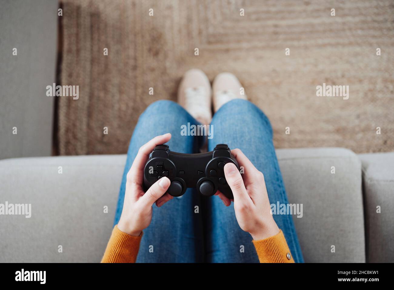 Woman playing game with joystick at home Stock Photo