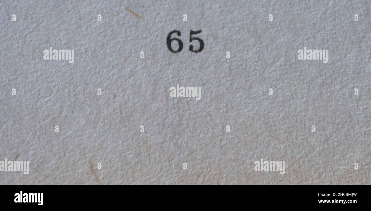 The number 65 printed on a piece of paper. Paper texture. Stock Photo