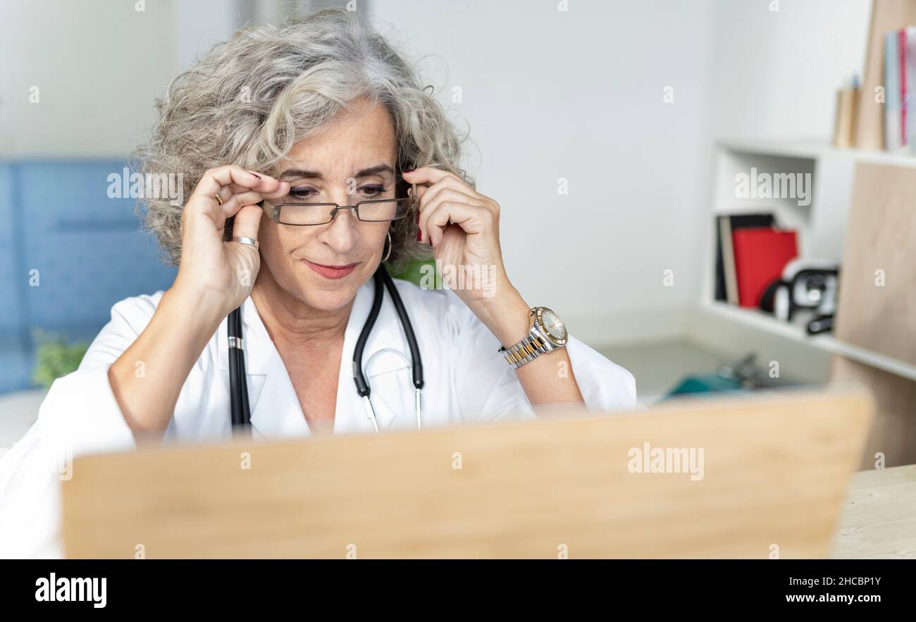 Senior female doctor arms crossed hi-res stock photography and images ...