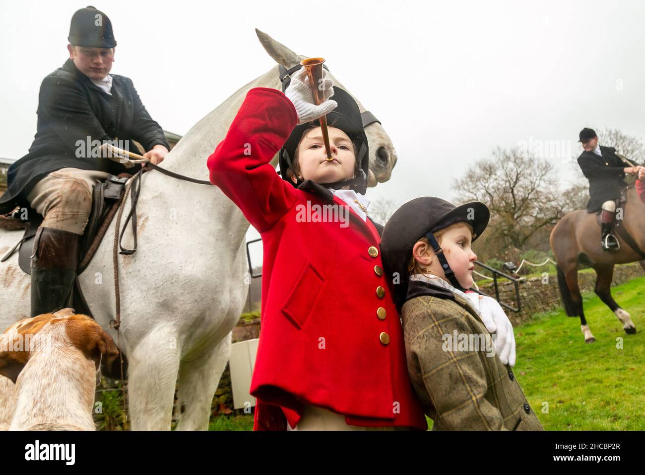 Hagley, Worcestershire, UK. 27th Dec, 2021. 8-year-old Henley Mills stands with his sister Myla-May, 2, among the hounds the first hunt at Hagley Hall since the Coronavirus pandemic. The Albrighton and Woodland Hunt meet annually at Hagley Hall in Worcestershire. Credit: Peter Lopeman/Alamy Live News Stock Photo