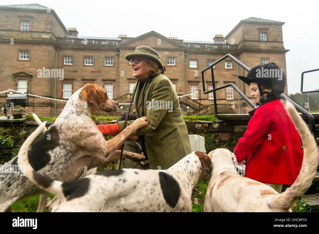 Hagley, Worcestershire, UK. 27th Dec, 2021. Hazel Sheppard with 8-year-old Henley Mills and the hounds of the Albrighton and Woodland Hunt at the first hunt at Hagley Hall since the Coronavirus pandemic. The Albrighton and Woodland Hunt meet annually at Hagley Hall in Worcestershire. Credit: Peter Lopeman/Alamy Live News Stock Photo