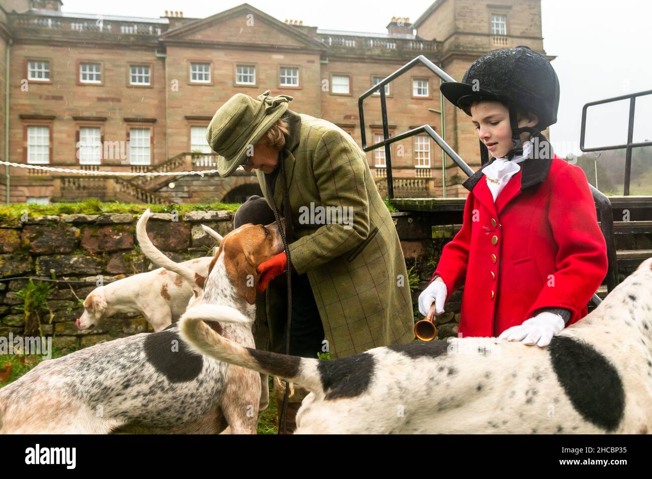 Hagley, Worcestershire, UK. 27th Dec, 2021. Hazel Sheppard with 8-year-old Henley Mills and the hounds of the Albrighton and Woodland Hunt at the first hunt at Hagley Hall since the Coronavirus pandemic. The Albrighton and Woodland Hunt meet annually at Hagley Hall in Worcestershire. Credit: Peter Lopeman/Alamy Live News Stock Photo