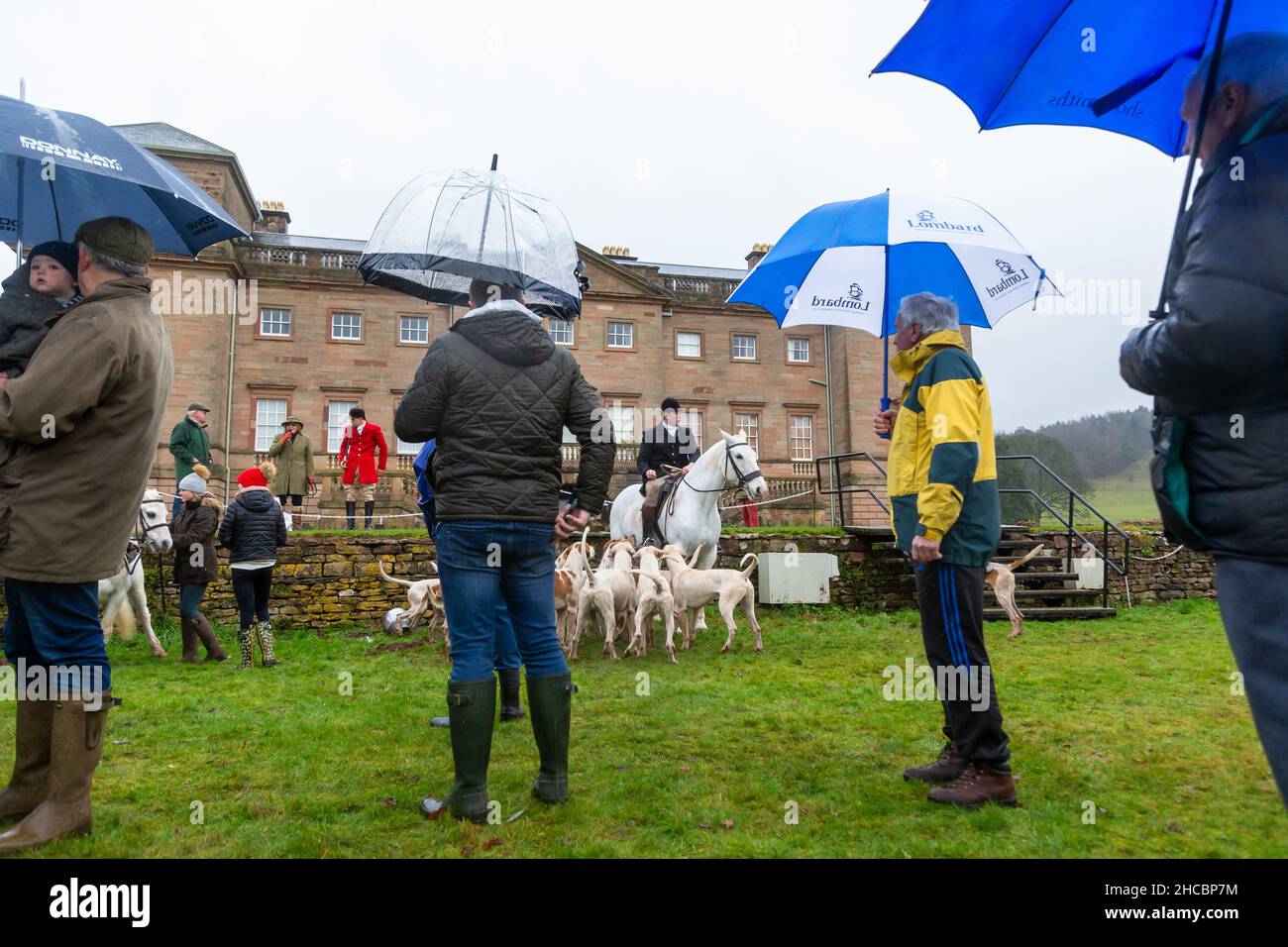 Hagley, Worcestershire, UK. 27th Dec, 2021. Horses and hounds gather with supporters in the rain for the first meet of the Albrighton and Woodland Hunt at Hagley Hall since the Coronavirus pandemic. The Albrighton and Woodland Hunt meet annually at Hagley Hall in Worcestershire. Credit: Peter Lopeman/Alamy Live News Stock Photo