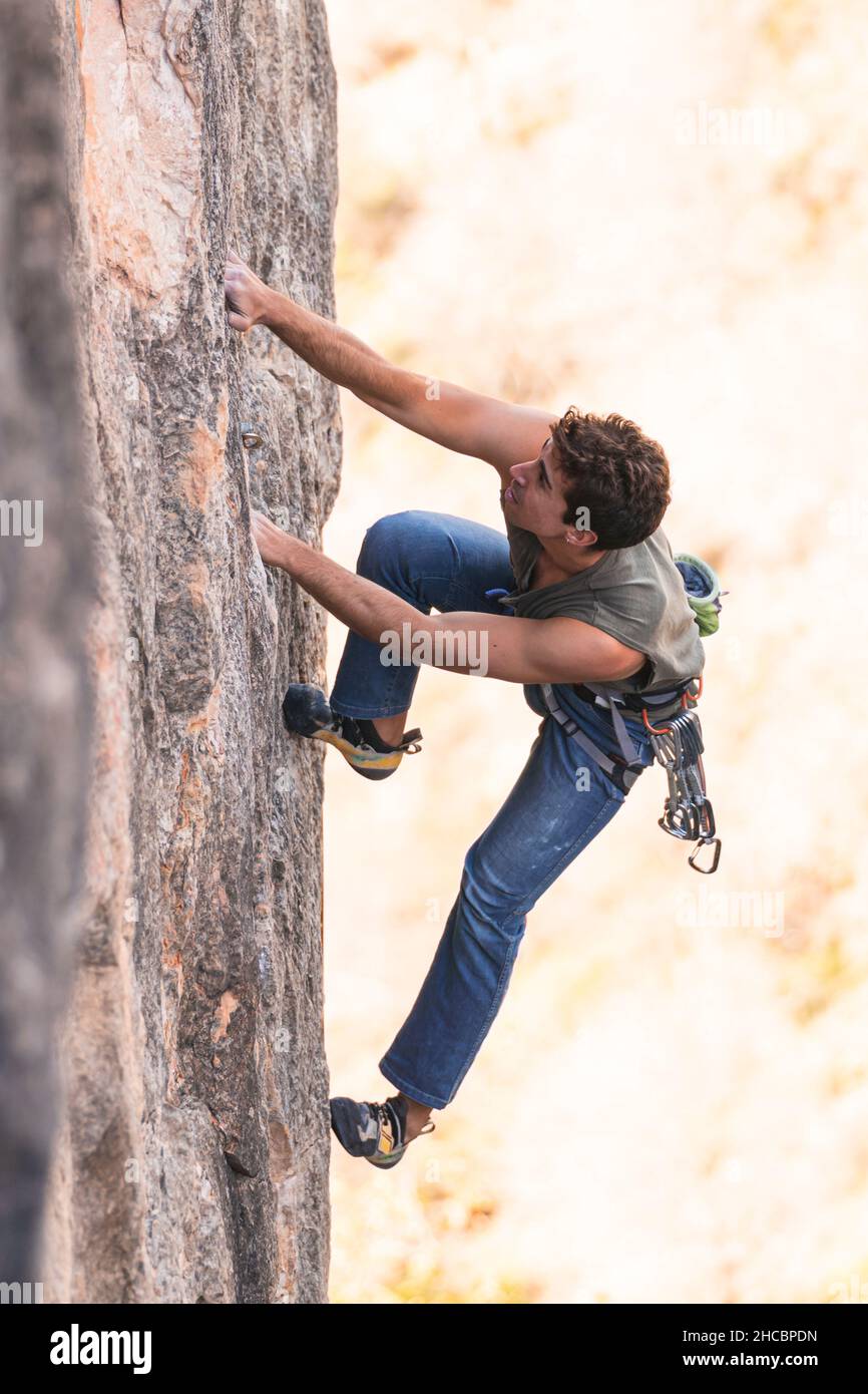 Hiker with safety harness hanging on climbing rope Stock Photo