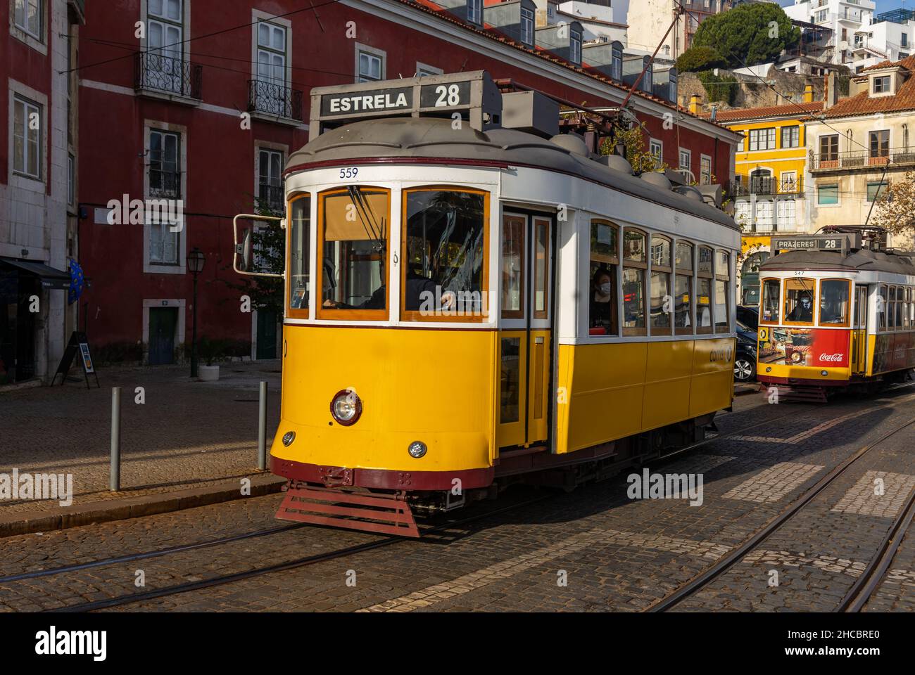 The historic yellow trams are a popular sight in Lisbon, Portugal. On