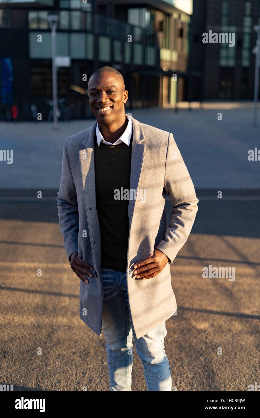 Smiling businessman leaning on railing Stock Photo
