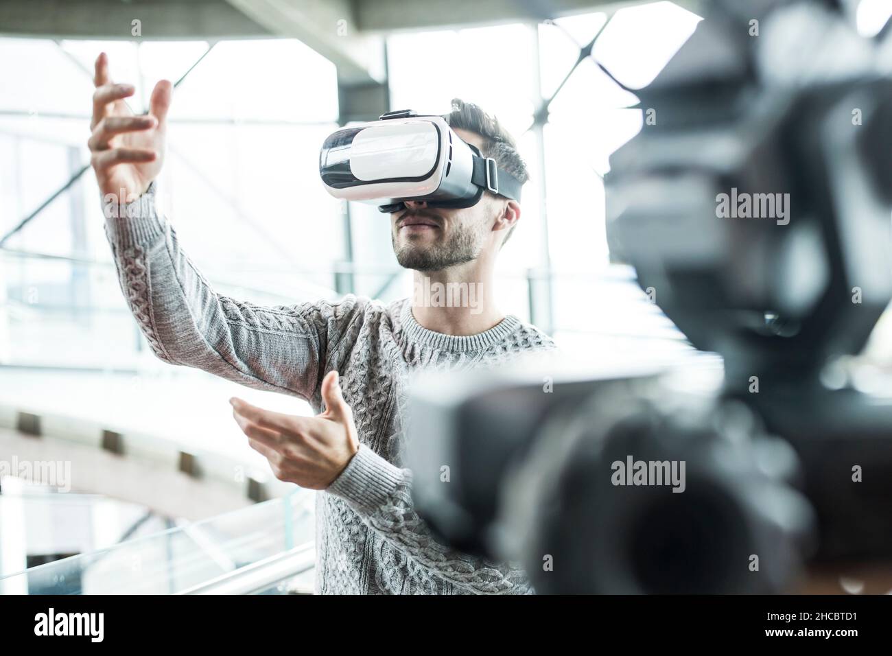Tech developer wearing virtual reality headset at robotic workshop Stock Photo