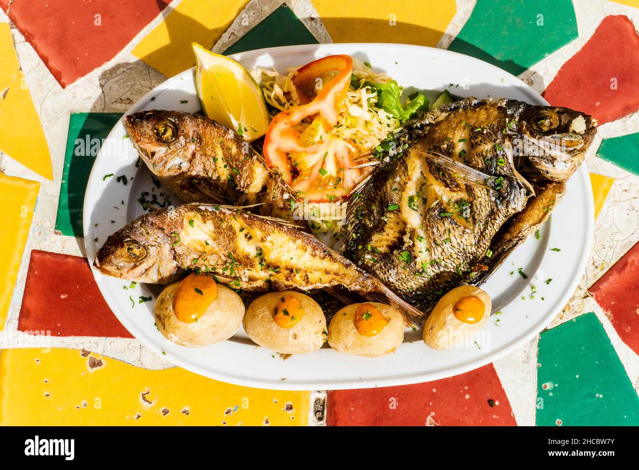 Deep fried fish with salad and traditional potatoes with red sauce in Gran Canaria, Canary Islands, Spain Stock Photo