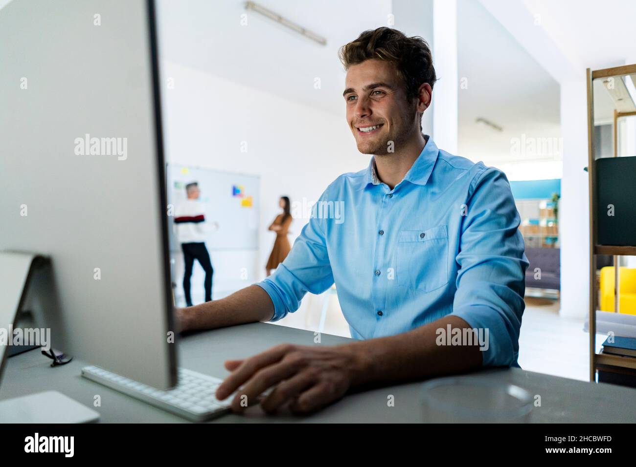 Happy coworkers working together in office Stock Photo